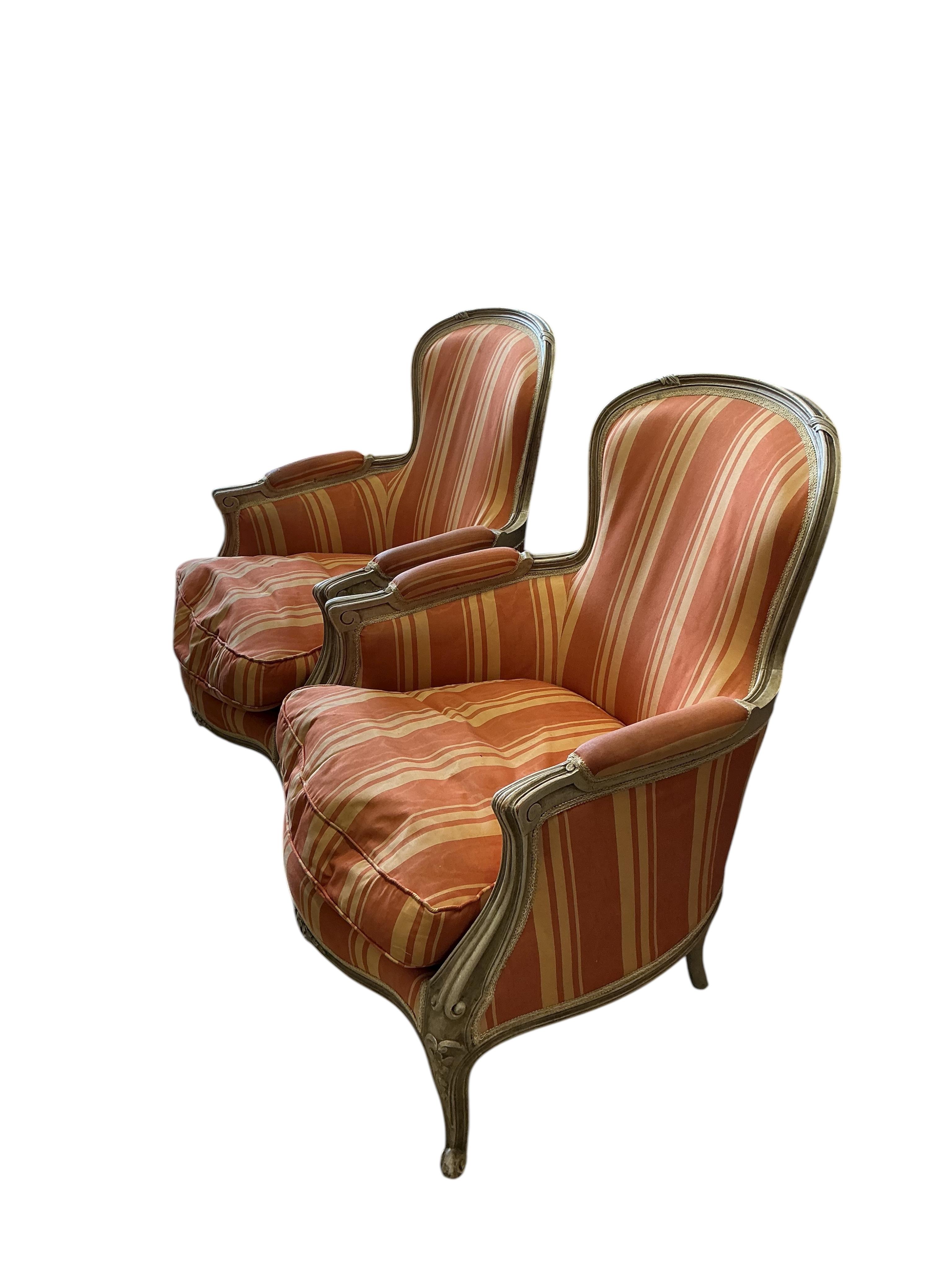 A pair of Louis XVI style painted upholstered armchairs, width 66cm, depth 60cm, height 88cm